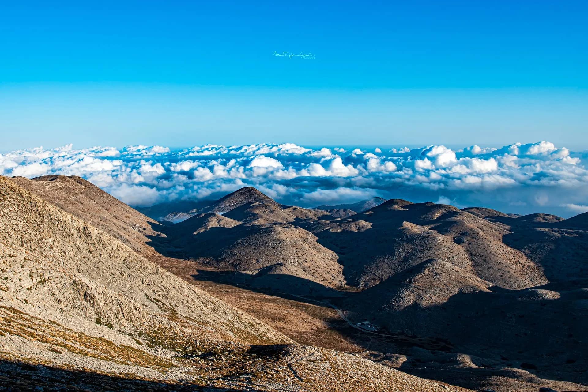 The mountains of Crete rising above the clouds, seen on an outdoor excursion