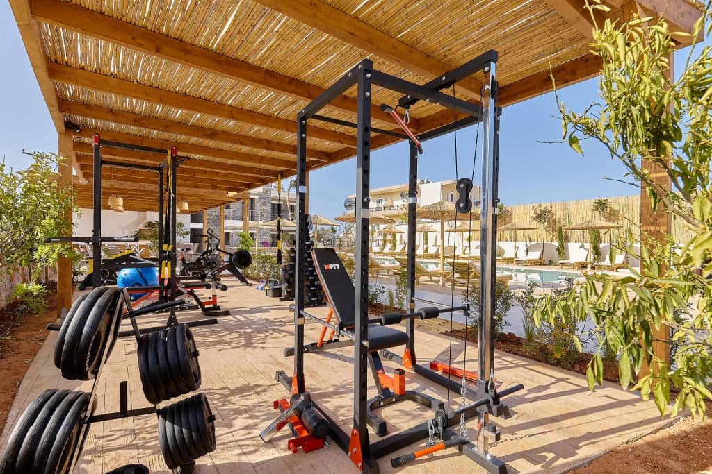 The fully equipped outdoor gym of Volta Suites and Villas with rack, free weights and benches