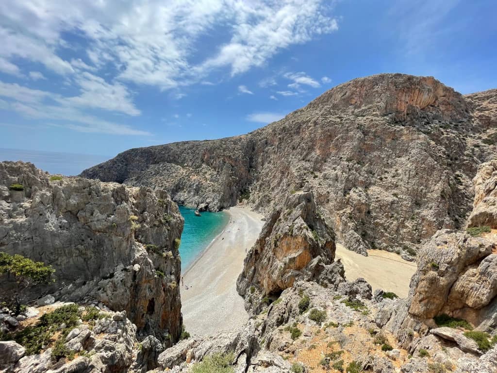 Hidden beach between steep cliffs on the coast of Crete