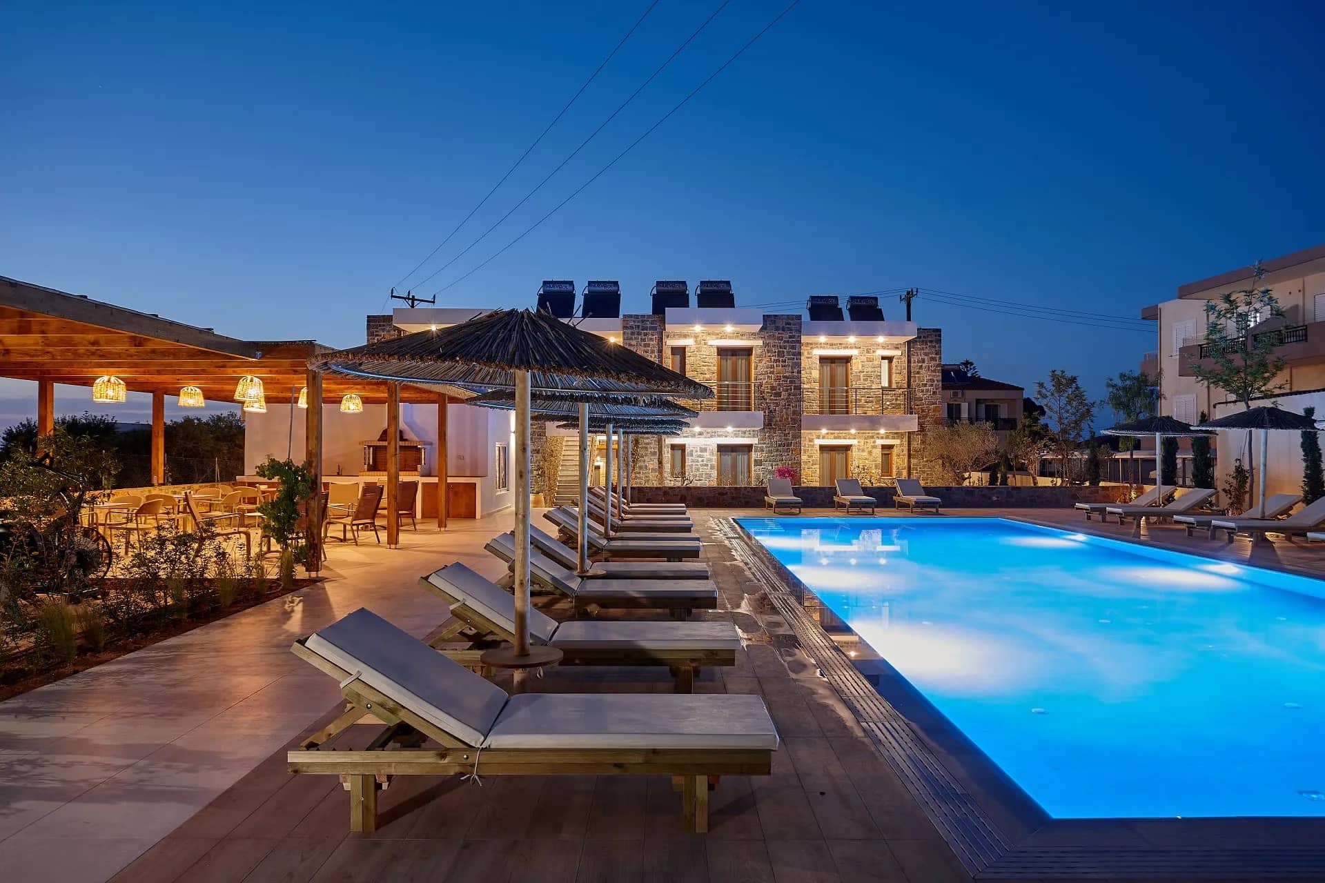 Βραδινή άποψη του χώρου της πισίνας στο Volta Suites and Villas